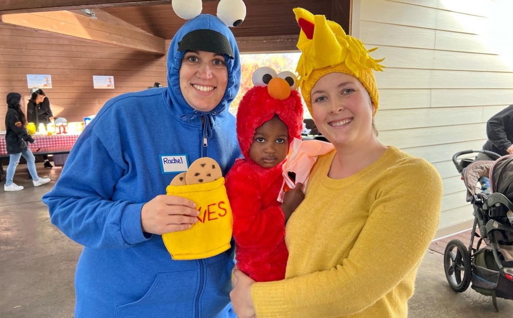 Family dressed up as Sesame Street Characters Cookie Monster, Elmo, and Big Bird at Fall Family Day