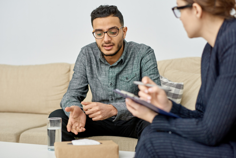 Young boy speaking with therapist during counseling appointment