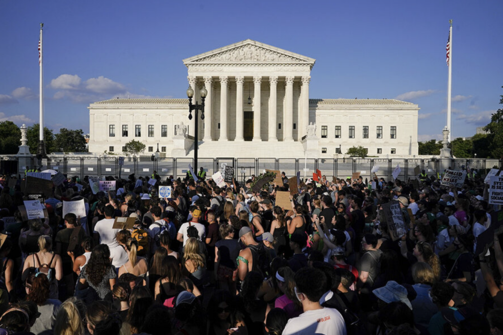 Protesters stand outside of the supreme court