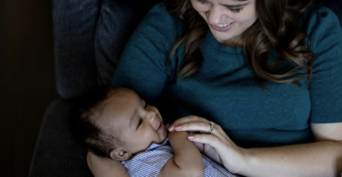 Young woman holding baby