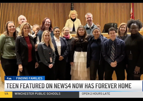 A screenshot from a news story featuring a child on the heart gallery who found her adoptive family. The family stands in court on her adoption day.