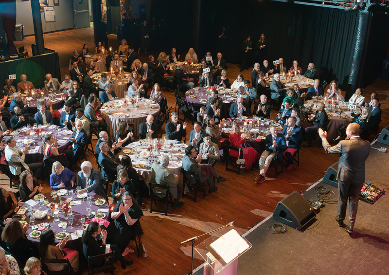 An auctioneer addresses the crowd at a gala