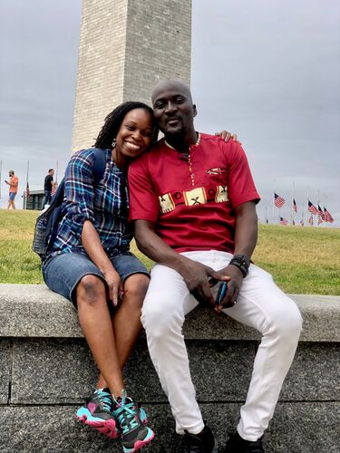 A couple smiles in front of the Washington Monument